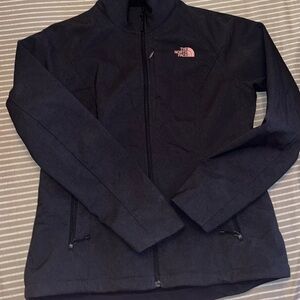 The North Face Dark Jacket with Pink Emblem